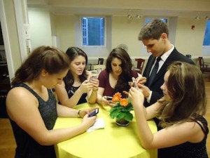 Young_people_texting_on_smartphones_using_thumbs